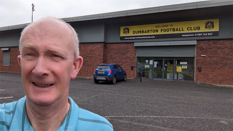 Self portait photo in front of the entrance to the Dumbarton Football Club ground